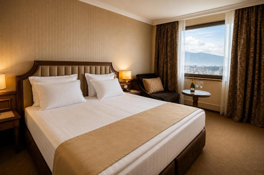 a hotel room with a large bed and a window at Astoria Grand Hotel in Sofia