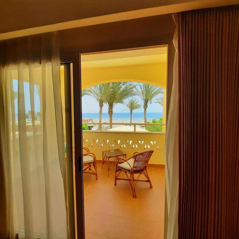 a balcony with chairs and a view of the ocean at Sharm Grand Plaza Resort - Families and Couples Only in Sharm El Sheikh