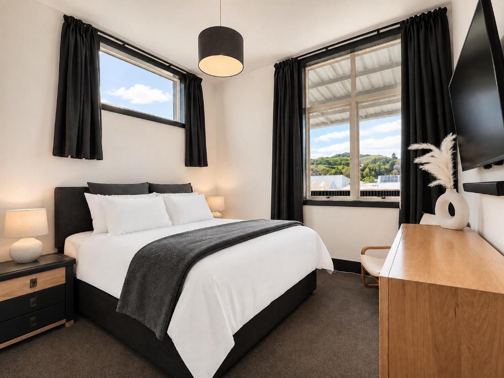 a bedroom with a bed and a window at The Nelson Loft - Sauna, Balcony & City Centre Living in Nelson