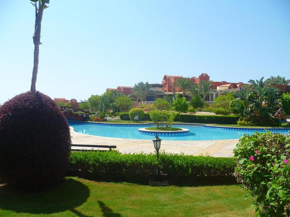 a large swimming pool with a fountain in a park at Sharm Grand Plaza Resort - Families and Couples Only in Sharm El Sheikh
