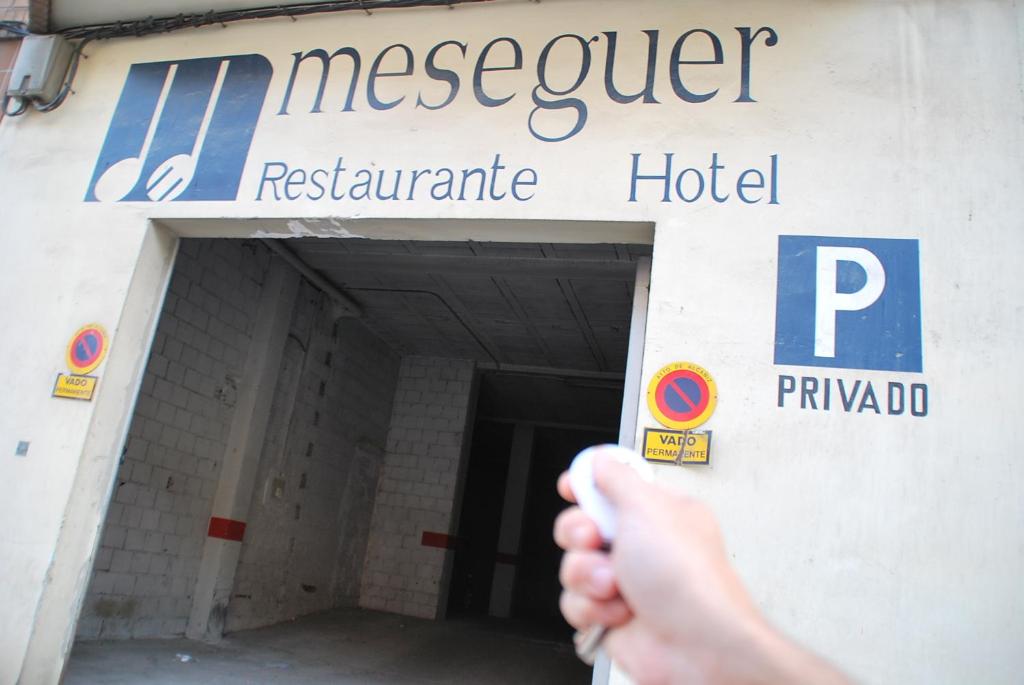 a person is standing in front of a hospital building at Aparthotel Meseguer in Alcañiz