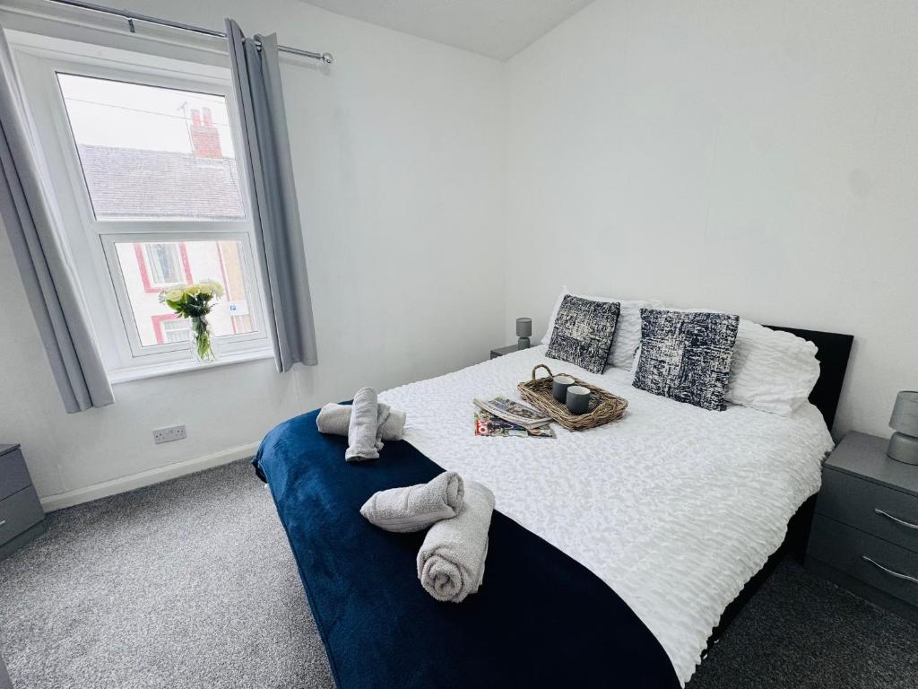 a bedroom with a bed with towels on it at Bolton Terrace - 2 Bedrooms - Sleeps 4 in Workington