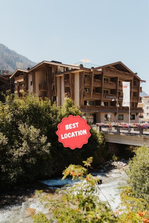 a hotel with a sign that reads best vacation at Hotel COSMEA - Your Dolomites & Honeymoon experience in Ortisei