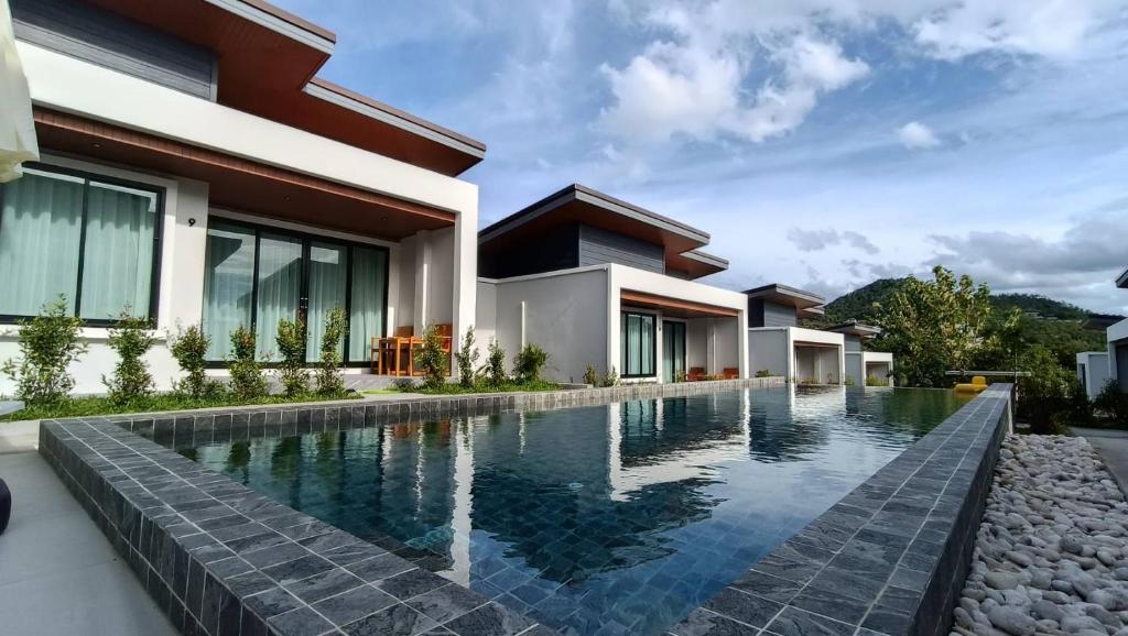 an image of a swimming pool in front of a house at Green Mountain View villas Koh samui in Plai Laem