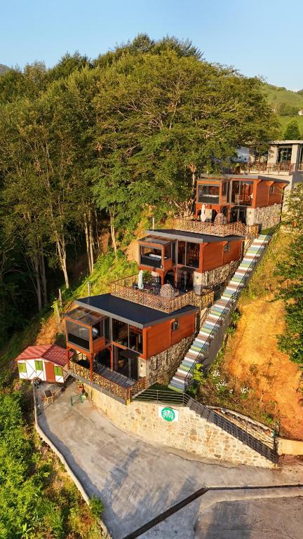 an aerial view of a house with a train at Novella Bungalov in Işıklı