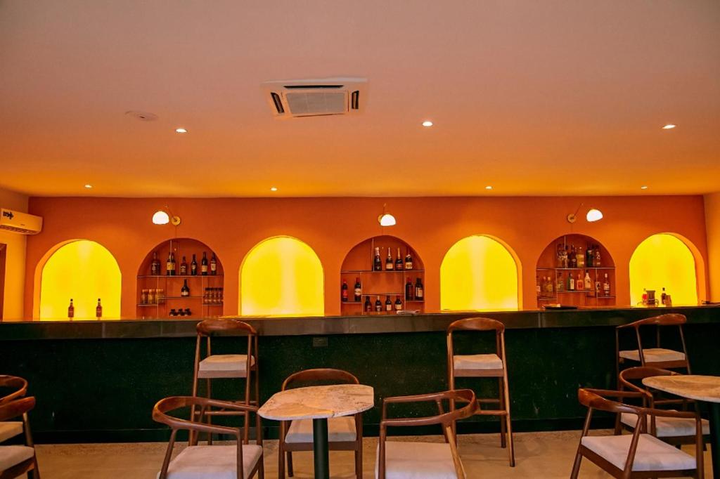 a bar with tables and chairs in a restaurant at SeaLord Resort in Abuja
