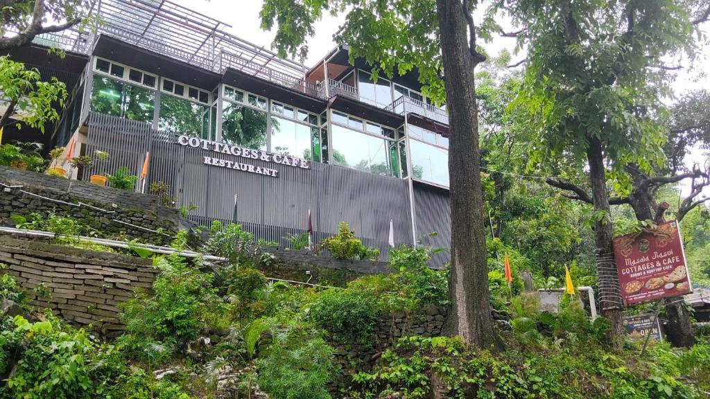 a building with a sign on the side of it at Cottages & Cafe in Dogadda