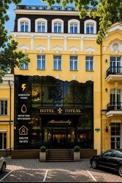 a yellow building with a hotel to fight at Alexandrovskiy Hotel in Odesa