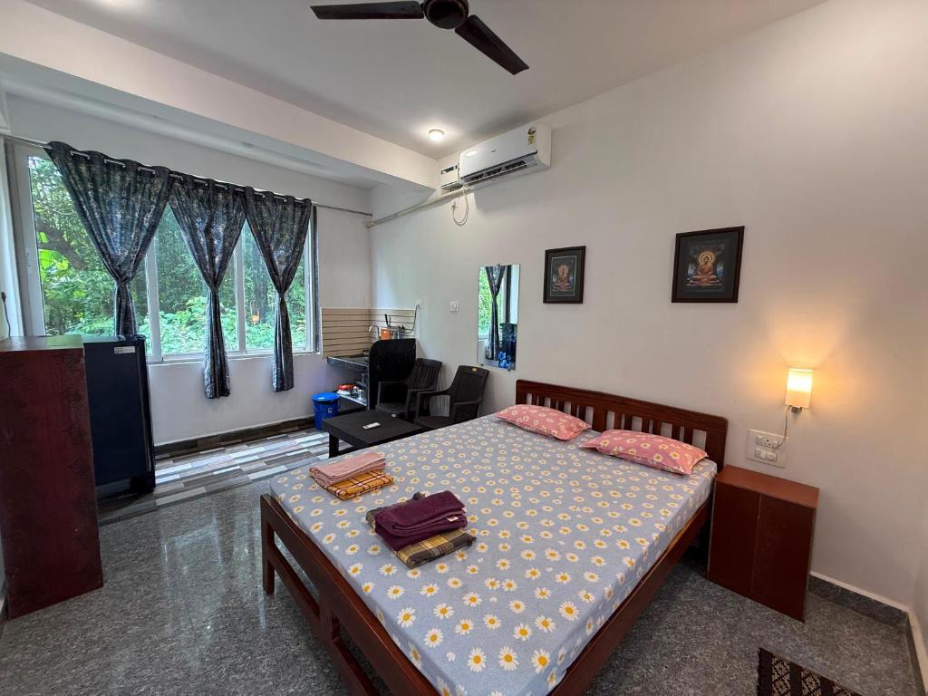 a bedroom with a bed and a living room at Studio Serinity Cove R-2 by Mukund Sadan Arambol in Arambol