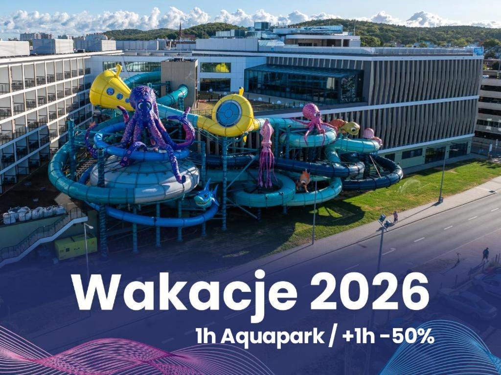 a water park with a water slide in a city at AQUA Resort AQUAPARK in Międzyzdroje