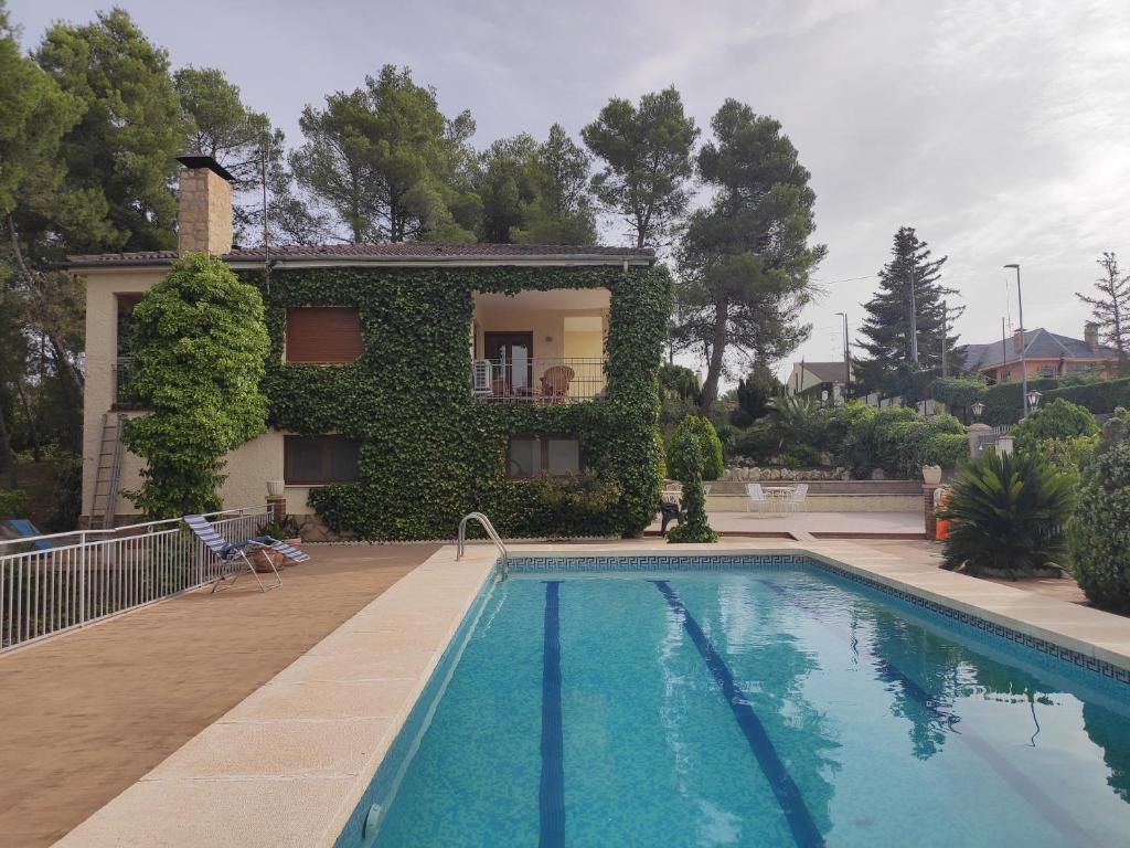 a house with a swimming pool in front of a house at Pedrera in Banyeres de Mariola