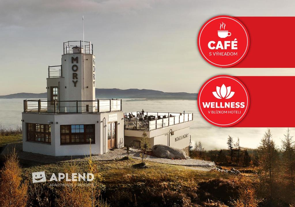 a building with a lighthouse next to a body of water at APLEND Monte Móry in Štrbské Pleso