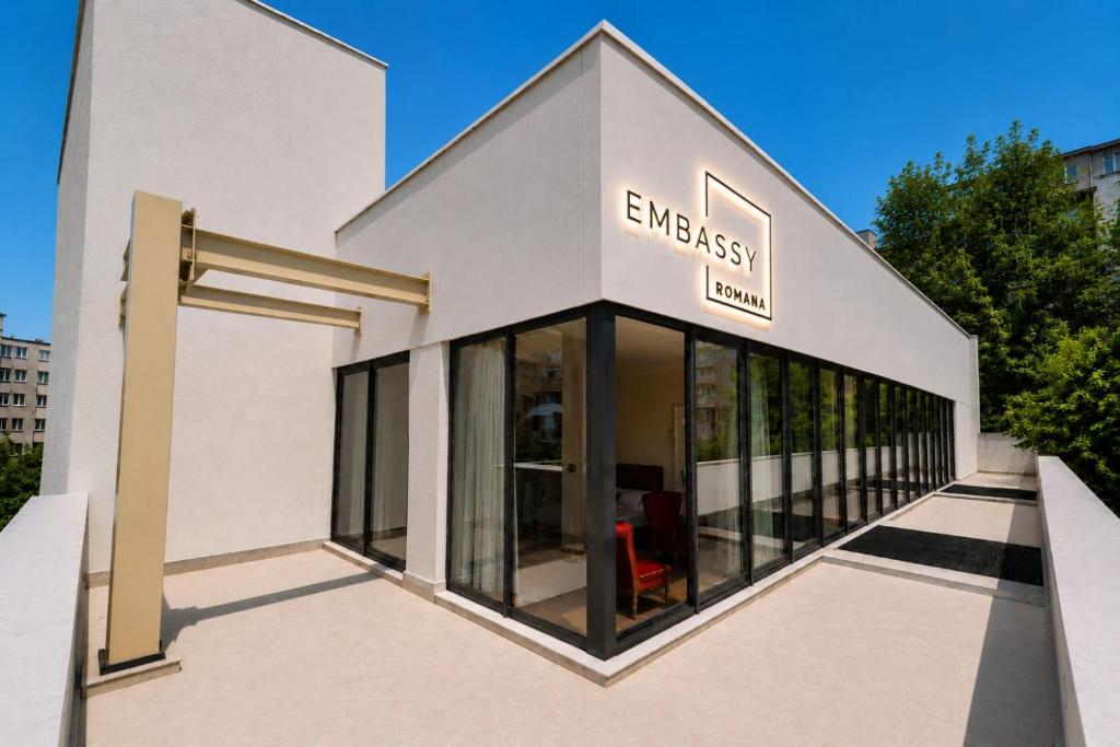 a building with a sign on the side of it at Embassy Romana in Bucharest