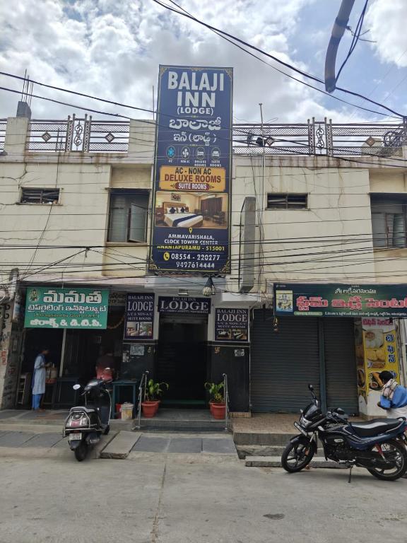 a building with two motorcycles parked in front of it at Balaji inn in Anantapur