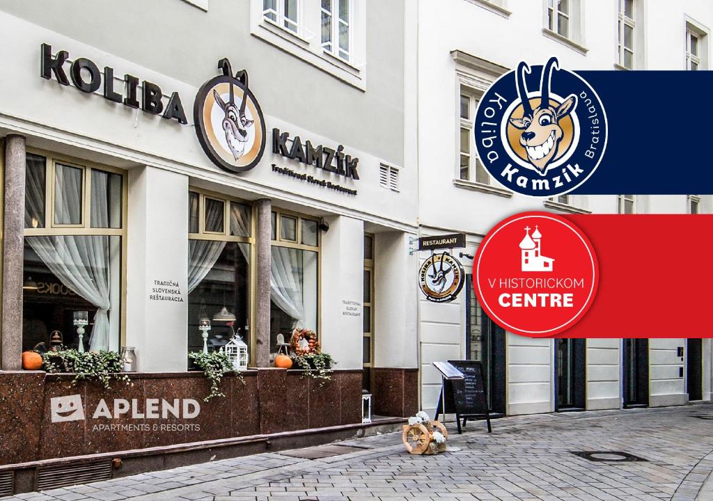 a building with a sign on the side of it at APLEND CITY Hotel Perugia in Bratislava