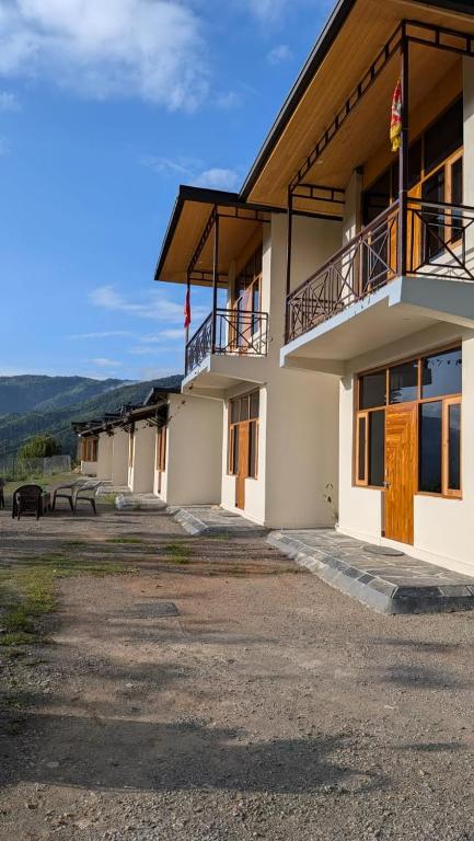 a building with two balconies on the side of it at The Himalayan Monarch in Chakrāta