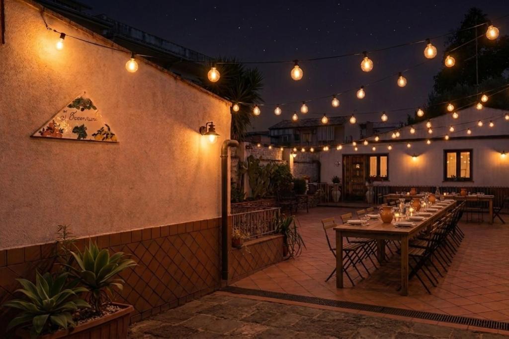 a patio with a table and lights on it at I Vacanzieri in Catania