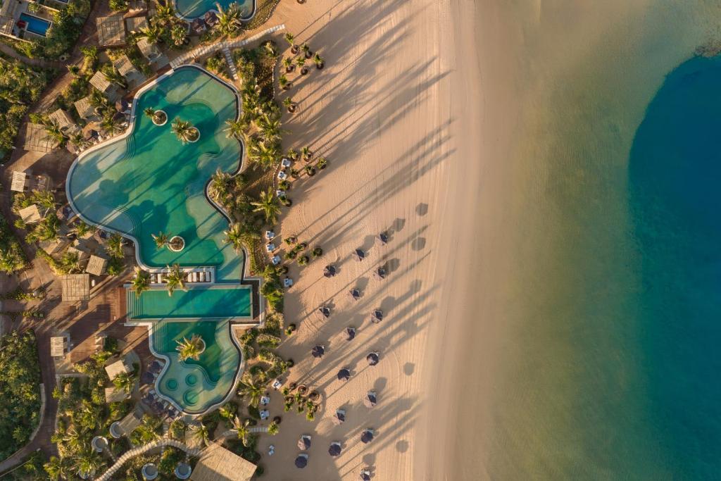 an overhead view of the beach and the ocean at Six Senses AMAALA in Amala