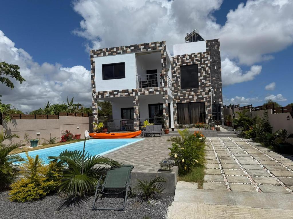 a house with a swimming pool in front of it at VR Villa in Trou d'Eau Douce