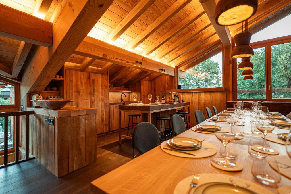 a dining room with a long table with wine glasses at Chalet Namapa in Saint-Martin-de-Belleville