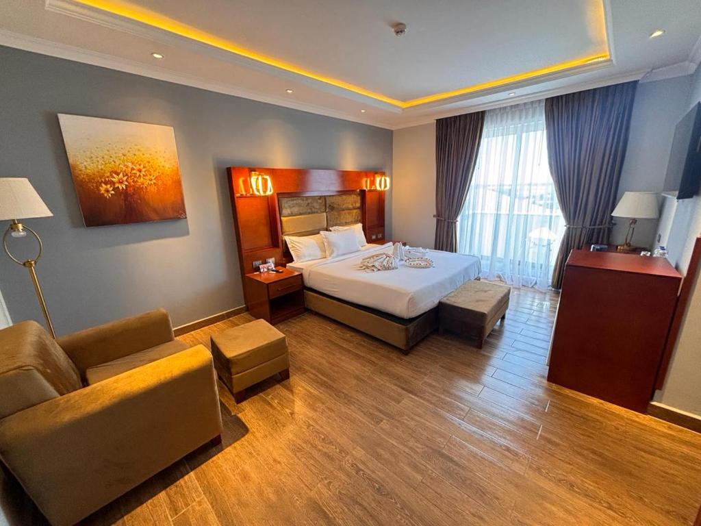 a hotel room with a bed and a couch at 2RN SOLOMON Hotel and Spa 