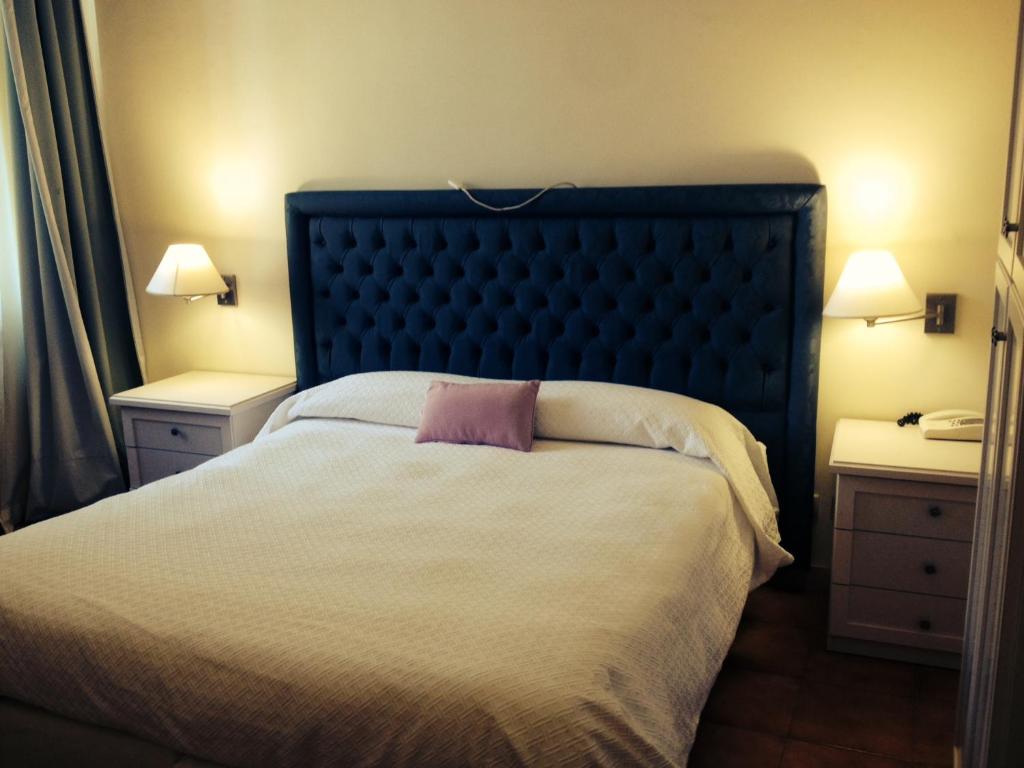 Postel nebo postele na pokoji v ubytování Hotel Miramare