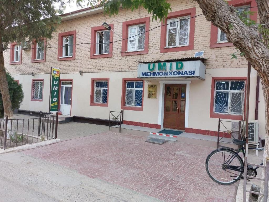 a building with a bike parked in front of it at Umid Hostel in Termiz