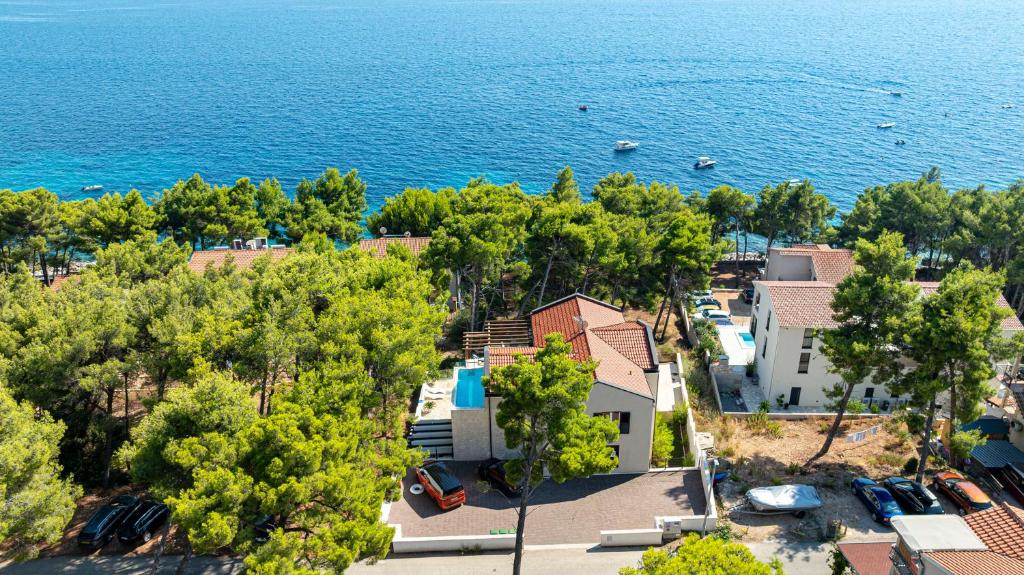an aerial view of a house and the water at Sunset Luxury Beach Apartment - Private Pool in Ivan Dolac