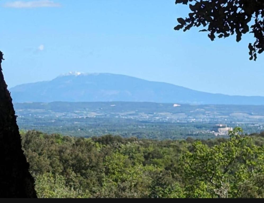 a view of a valley with a mountain in the distance at Grignan Glamping 2 -4 people exceptional view in Réauville