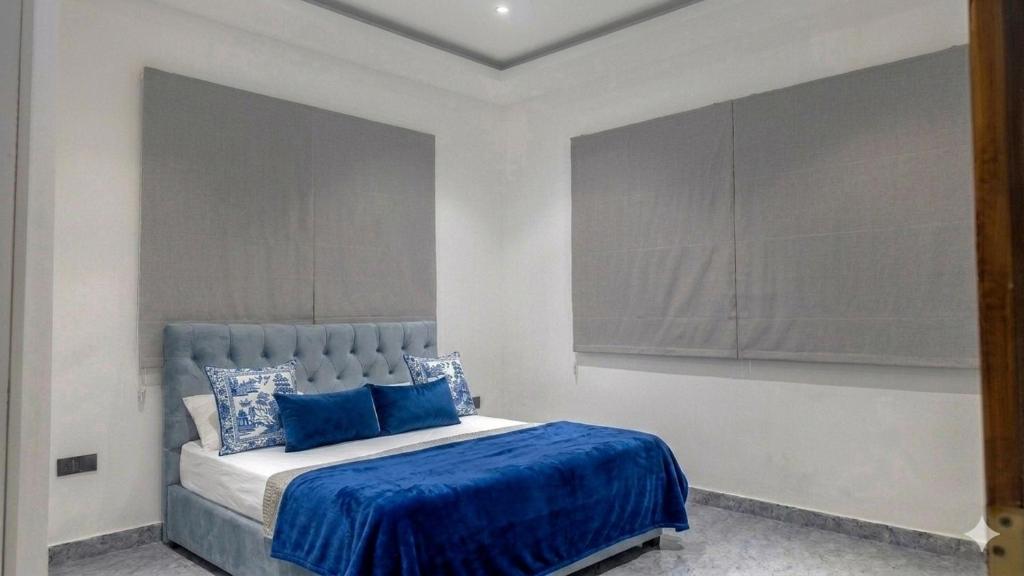 a bedroom with a large bed with blue sheets at The Harmony Mount Lavinia in Dehiwala