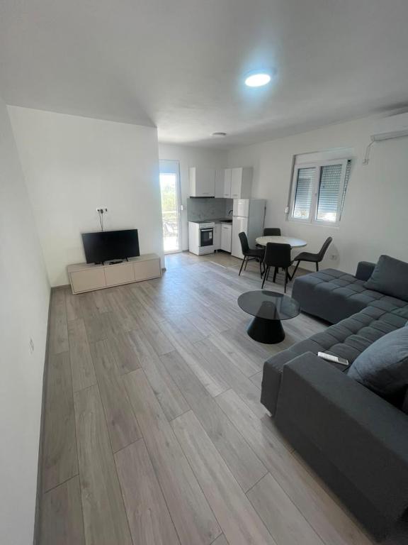 a large living room with a couch and a table at Rujovic 