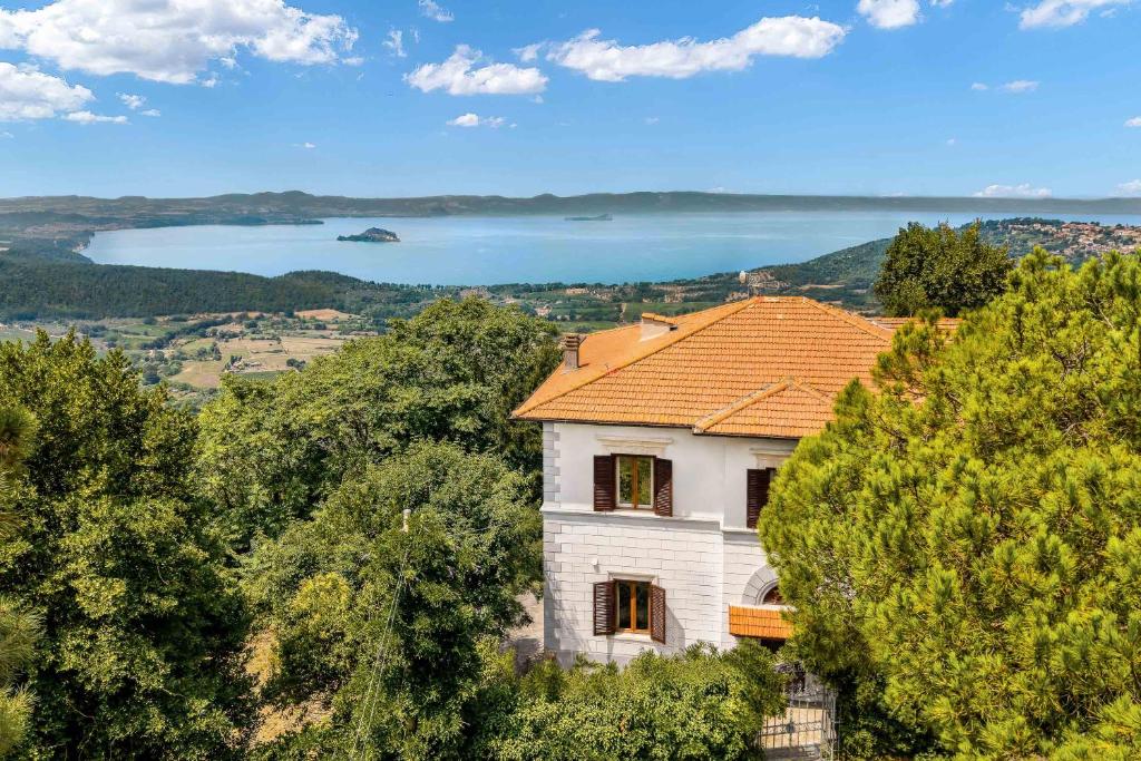 a house on a hill with a view of a lake at TorripaCollection - Villa Livia - Bolsena Lake in Montefiascone