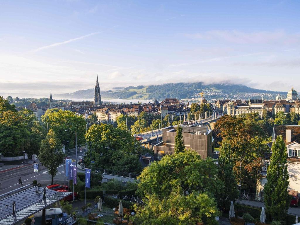 a view of a city with trees and a street at Swissôtel Kursaal Bern in Bern