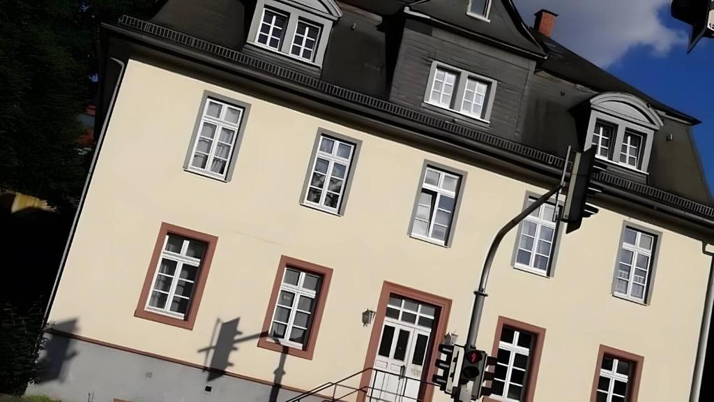 a large white building with a black roof at Haus Lindheim in Altenstadt