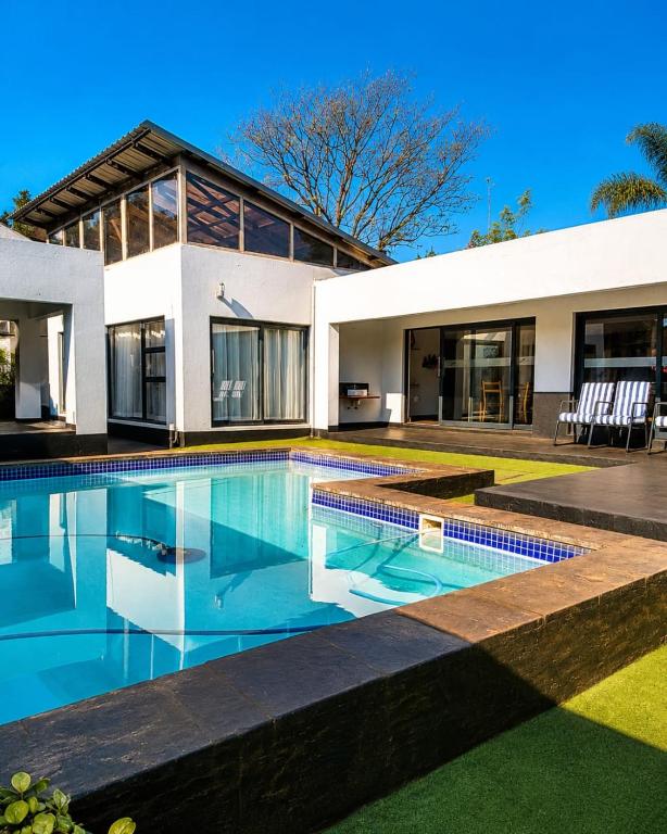 a house with a swimming pool in front of it at ANISA GUESTHOUSE in Thohoyandou