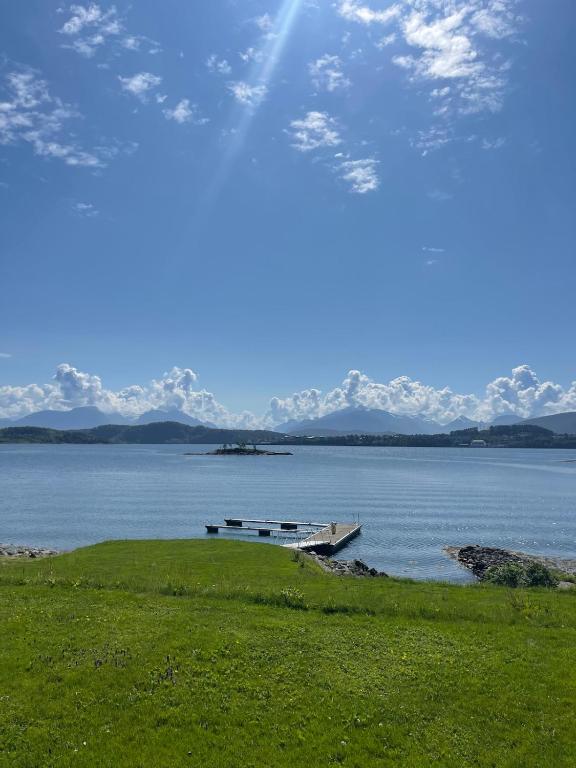 a boat sitting on the shore of a body of water at The Hidden Gem in Ålesund
