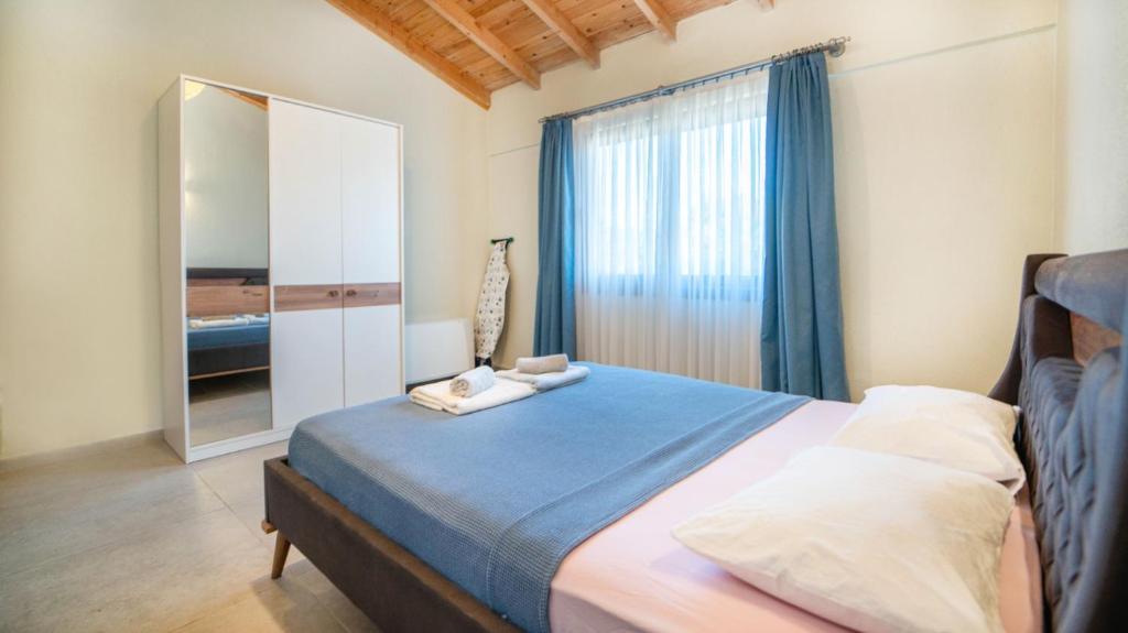 a bedroom with a large bed with a mirror at Villa Lagerta in Kayakoy