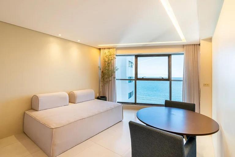 a living room with a couch and a table at HY BEACH FLATS - INTERNATIONAL in Recife