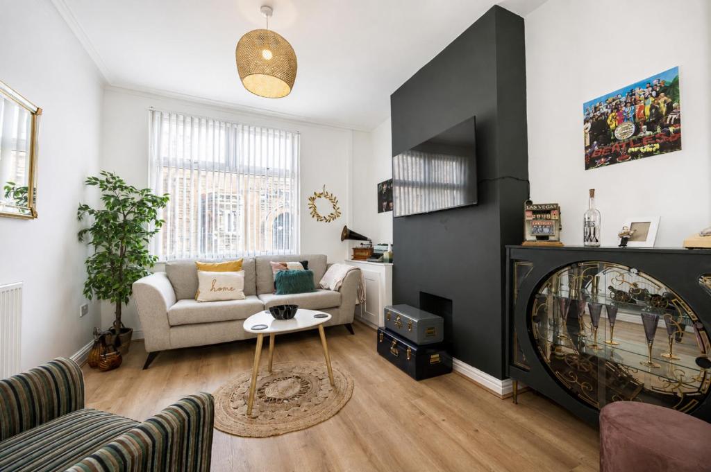 a living room with a couch and a fire place at Earp House - Allerton Liverpool Stay - Sleeps 7 in Liverpool