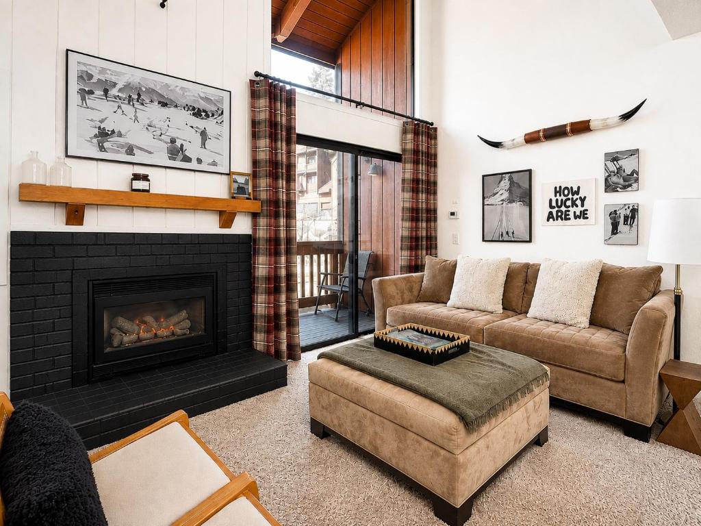 a living room with a couch and a fireplace at Epic Condo walk to Canyon Lodge in Mammoth Lakes