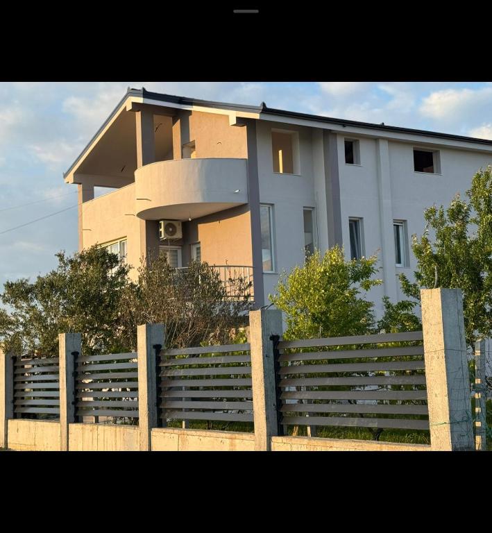 a large house with a fence in front of it at Apartament Jony in Hamallë