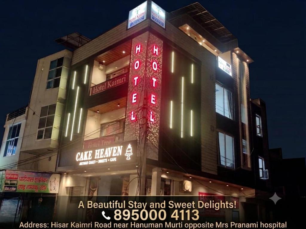 a building with a red sign on the side of it at HotelTree in Hisār
