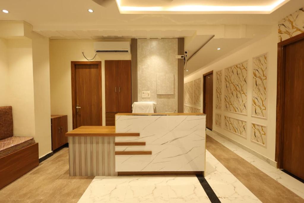 a lobby with a reception desk in a building at Yu Hotel in Kānpur