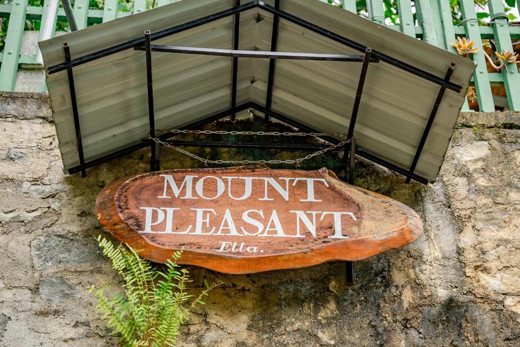 a sign on the side of a stone wall at MOUNT PLEASANT ELLA in Ella
