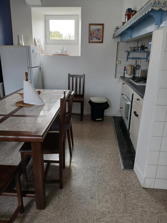 a kitchen with a wooden table and a dining room at Studio in Pontacq