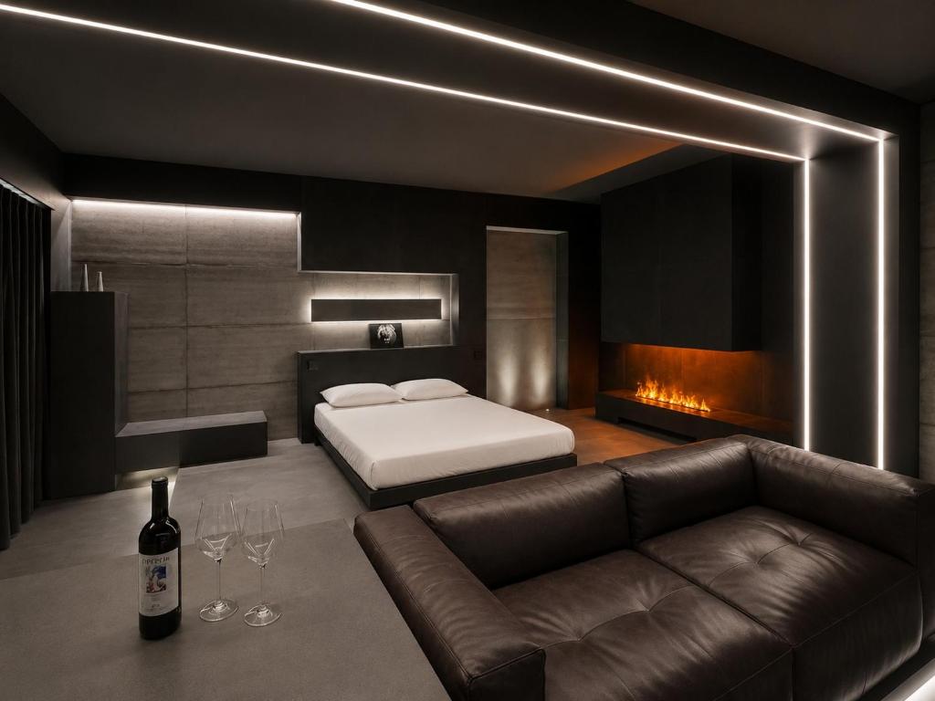 a bedroom with a bed and a couch with a bottle of wine at Agarthi Suites in Piateda