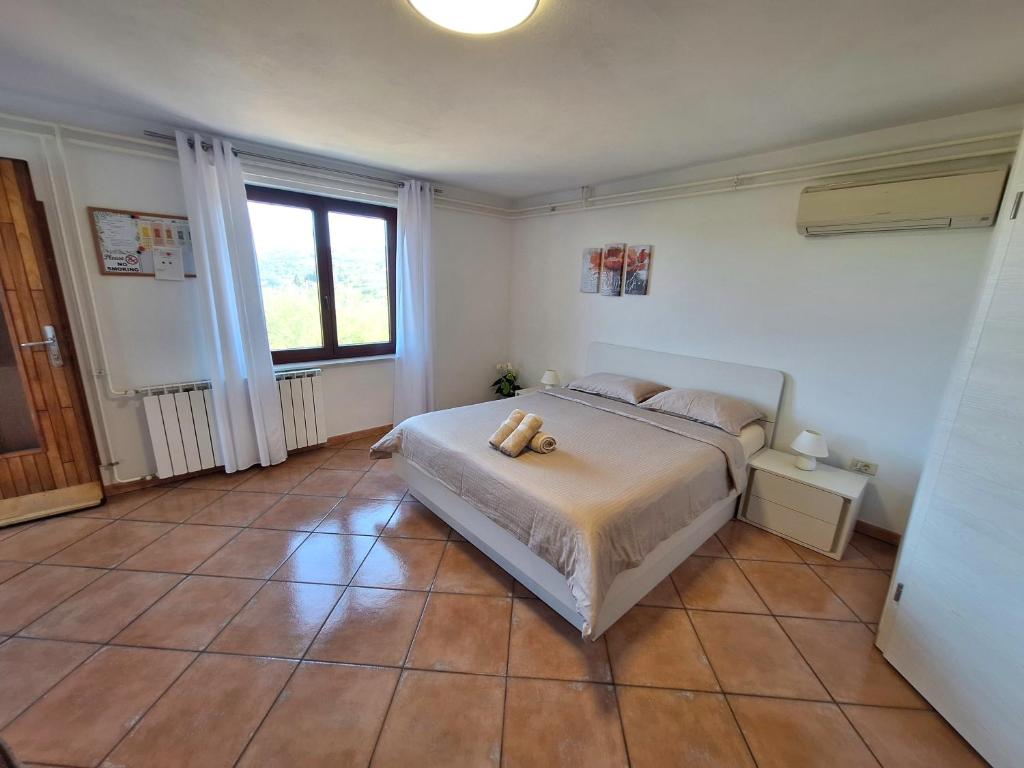 a bedroom with a bed with a stuffed animal on it at Apartment Burja with Olive Grove & Salt Pans View in Portorož