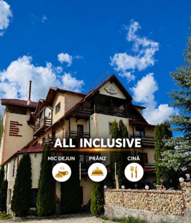 a building with an all inclusive sign in front of it at Hotel Bran Dracula in Bran