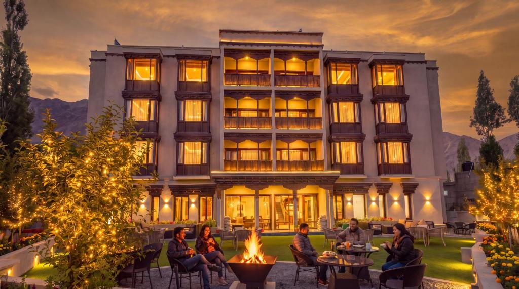 a group of people sitting in chairs in front of a building at The Bodhi Tree Ladakh in Leh
