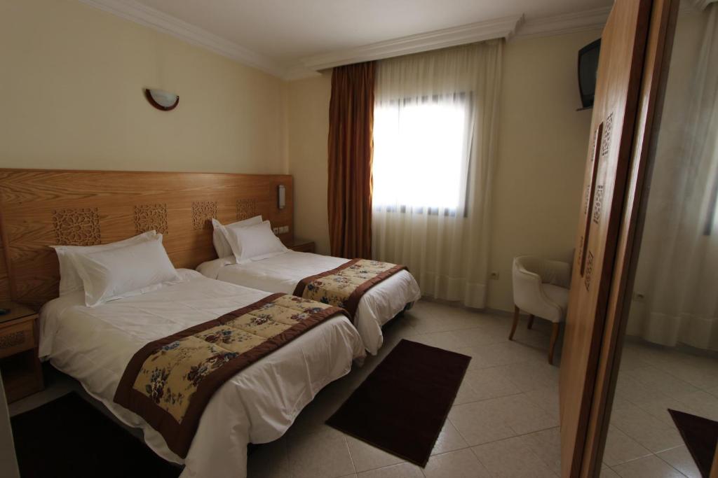 Postel nebo postele na pokoji v ubytování Hotel El Djenina